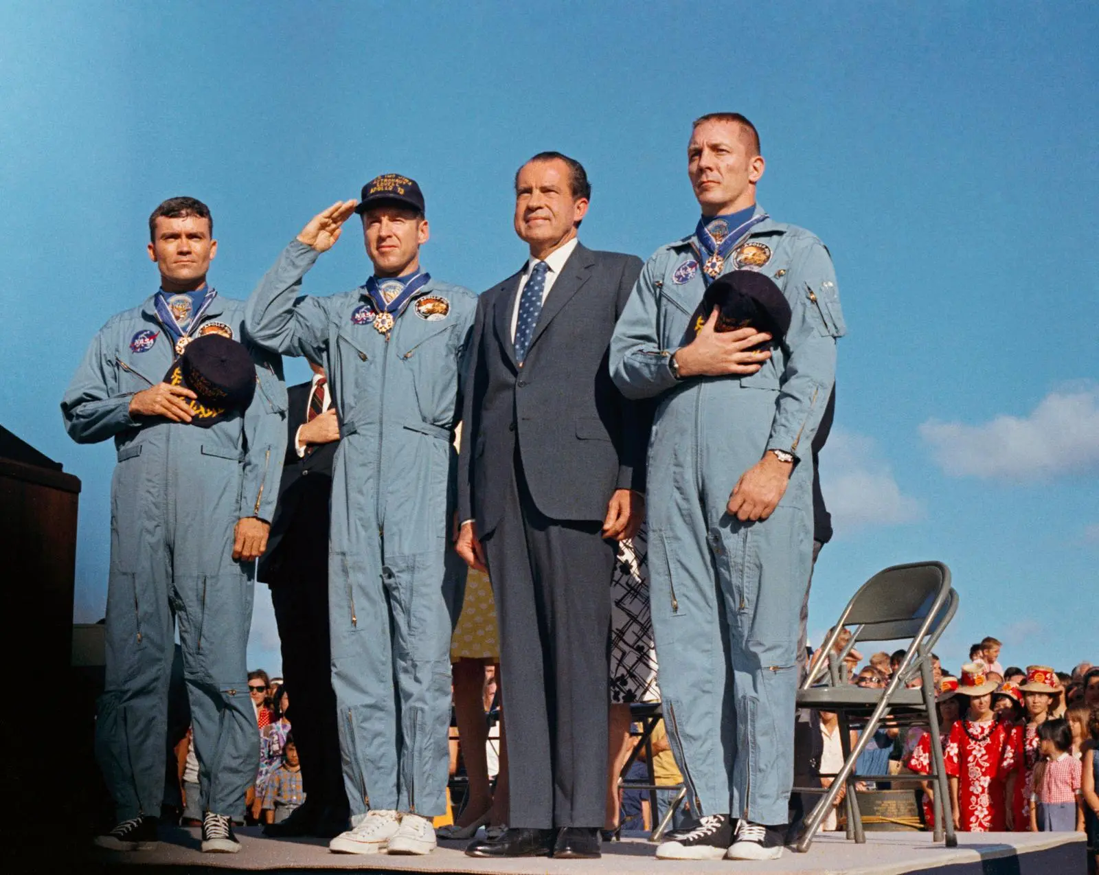 Lovell salutes beside Haise, President Nixon and Swigert at Hickam Air Force Base, Hawaii, after the crew received the Medal of Freedom, 18 April 1970 (S70-15526)