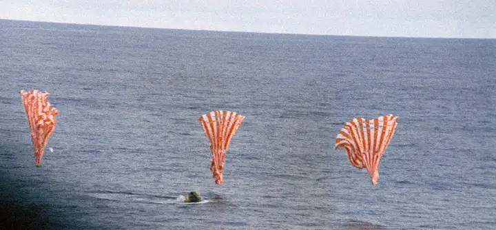 Odyssey splashes down in the South Pacific as its three main parachutes collapse, 17 April 1970 (S70-35644)