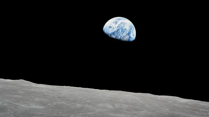 Earthrise: the Earth rises over the lunar horizon on Apollo 8’s fourth orbit, Christmas Eve 1968, in Bill Anders’s first color frame (AS08-14-2383)