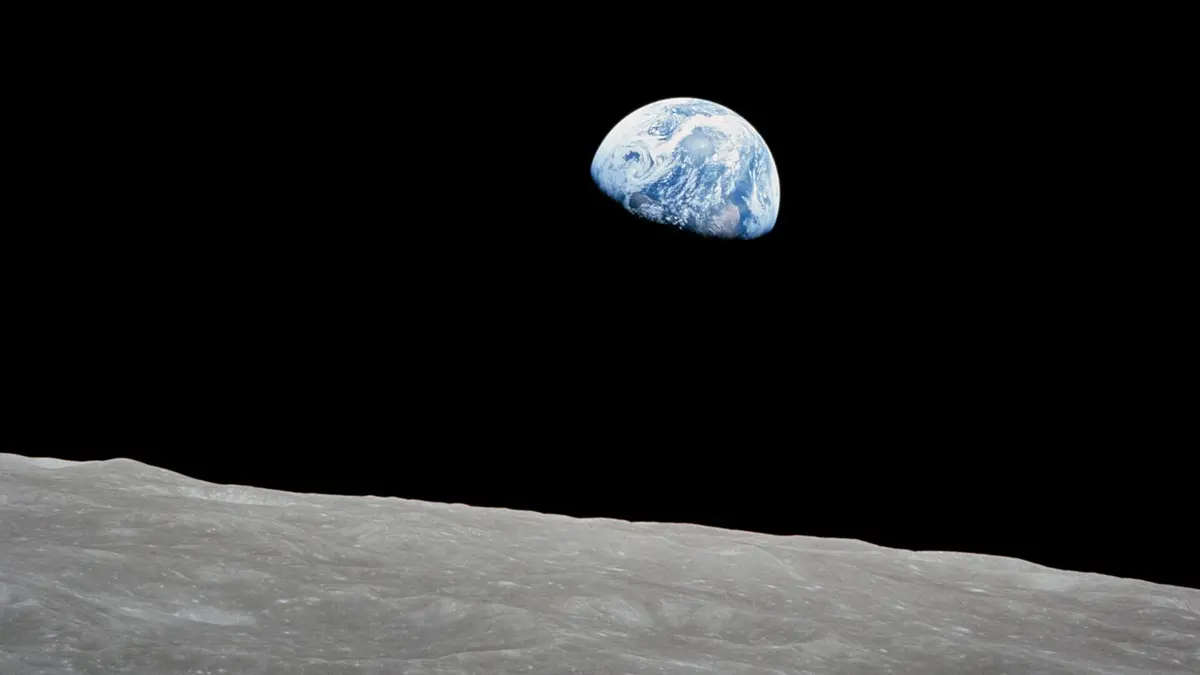 Earthrise: the Earth rises over the lunar horizon on Apollo 8’s fourth orbit, Christmas Eve 1968, in Bill Anders’s first color frame (AS08-14-2383)