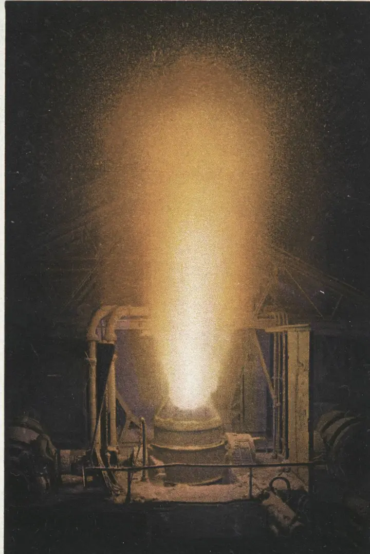 A Bessemer converter throws its flame at a Pittsburgh steel works, on a Detroit Publishing Co. postcard of the early 1900s.