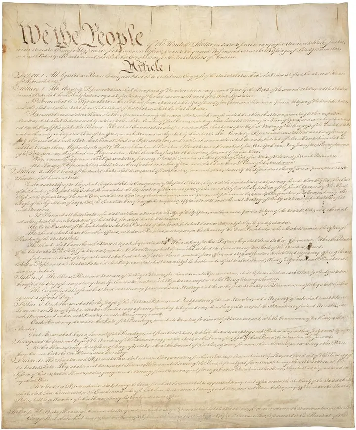Page one of the signed Constitution, opening with the words We the People.