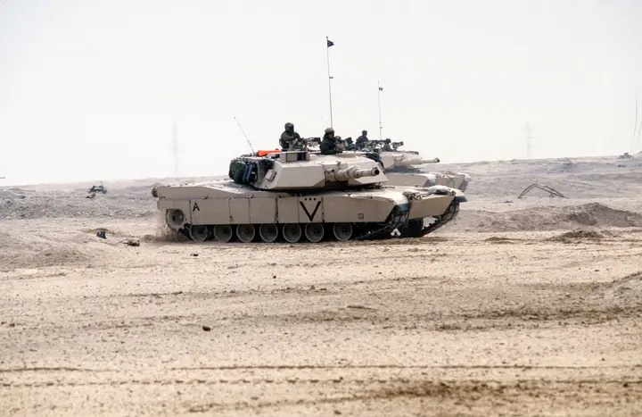 Marine M1A1 Abrams tanks cross the Kuwaiti desert on the first day of the ground war, 24 February 1991.