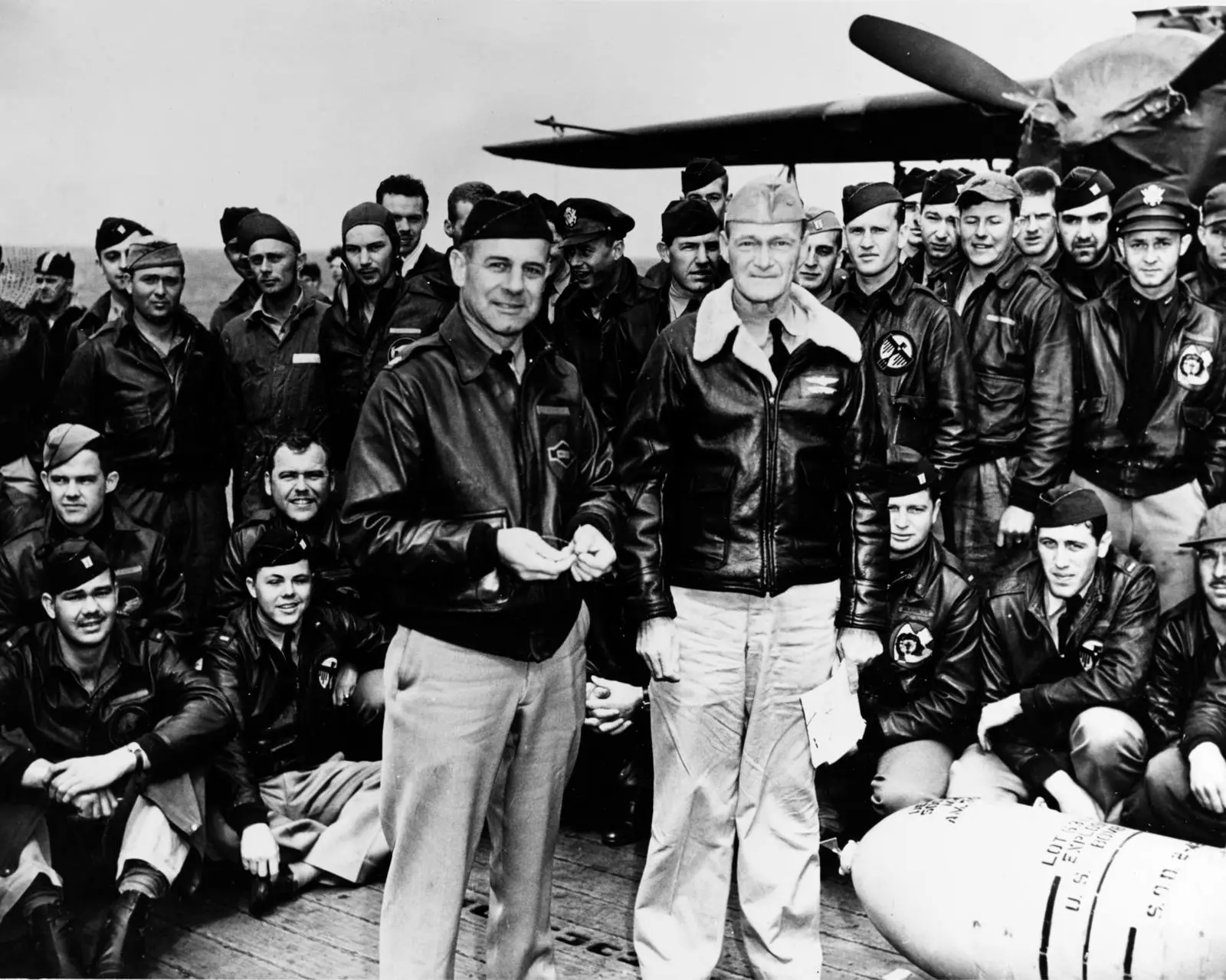 Lt. Col. Jimmy Doolittle and Capt. Marc Mitscher with Raider aircrews and a 500-pound bomb on Hornet’s flight deck before the raid (NH 64472).