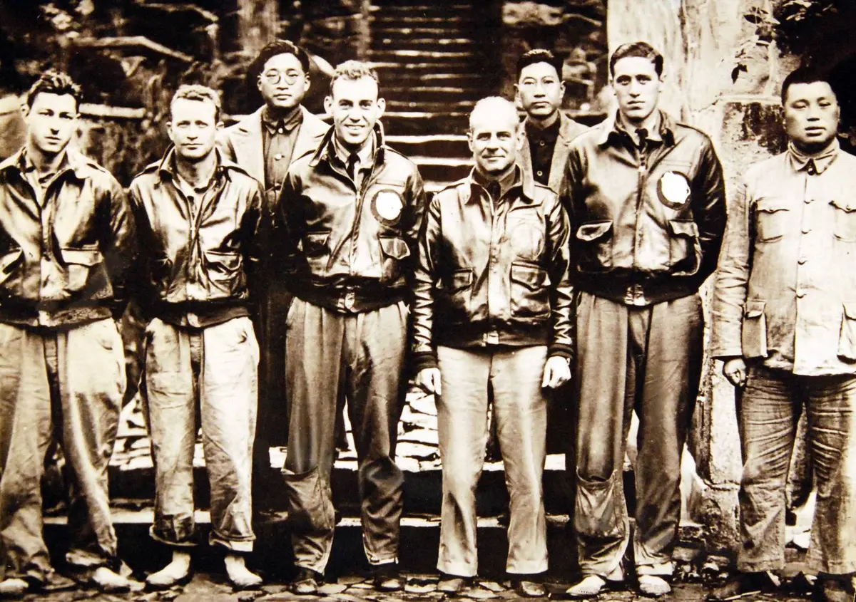 Doolittle (center) and his crew with Chinese officials who helped them in Chekiang Province after the raid (208-N-9092-P).