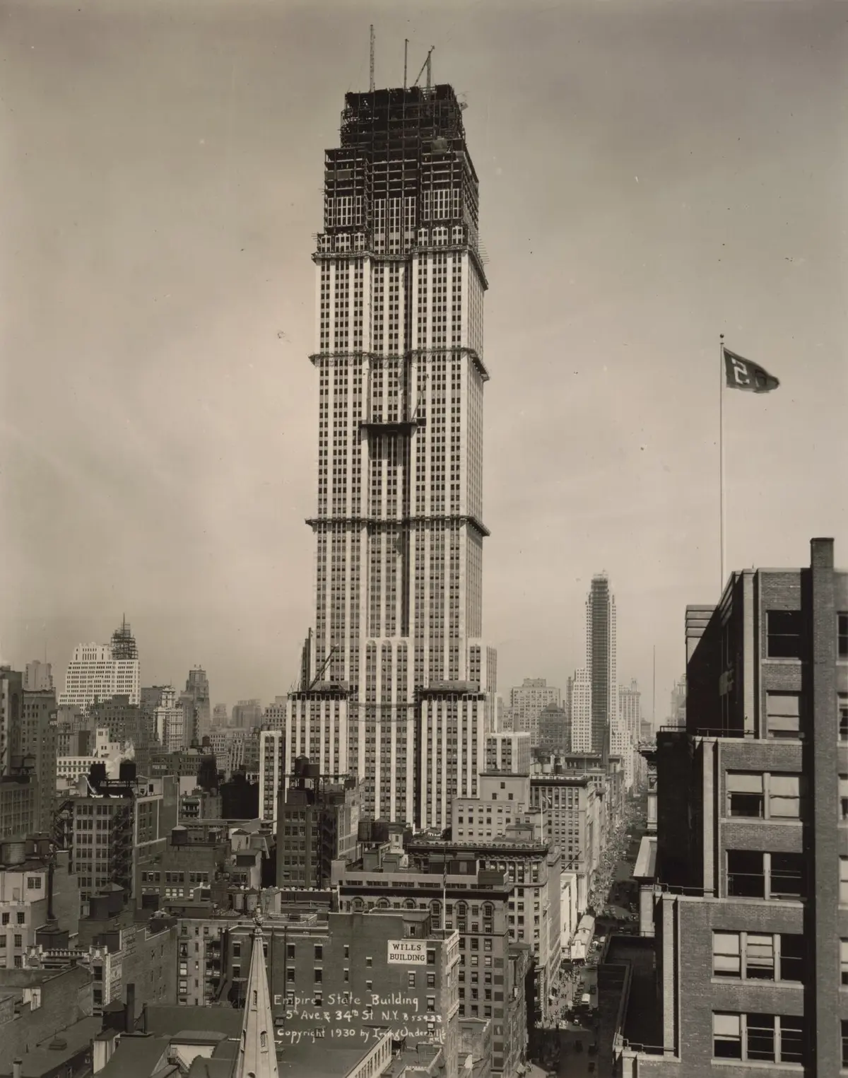 The Empire State Building nears its full height over Fifth Avenue and 34th Street, 1930.