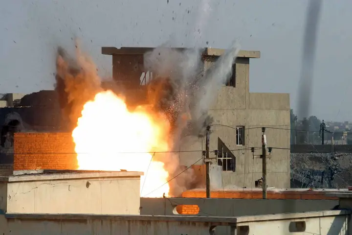 A precision air strike destroys an insurgent stronghold as 3d Battalion, 1st Marines, pushes through Fallujah, 10 November 2004.