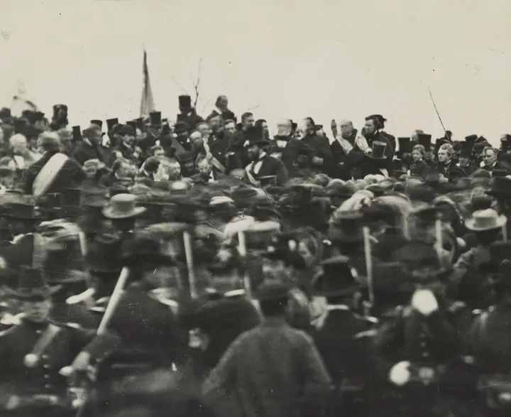 Lincoln, bareheaded near the center, sits among the dignitaries on the platform at Gettysburg about noon on 19 November 1863. Archivist Josephine Cobb found him in this plate in 1952.