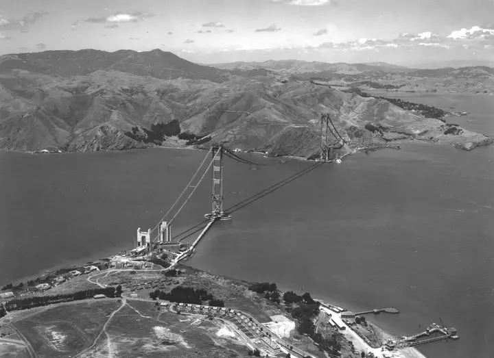 The towers and nearly finished main cables from the air, looking north to Marin, 19 May 1936.
