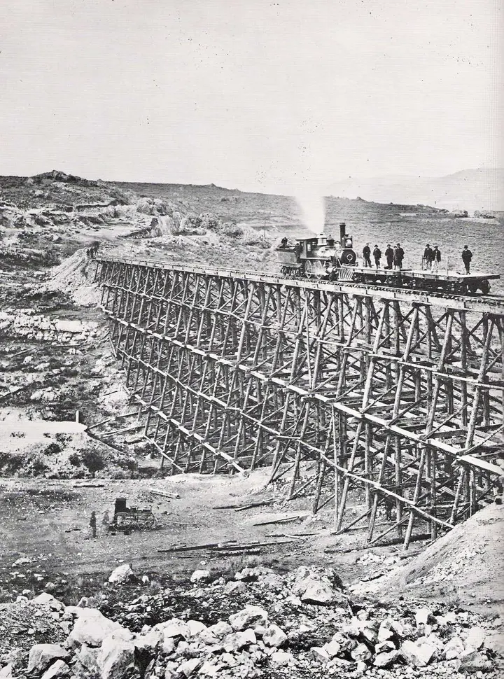 Union Pacific No. 119 crosses the Big Trestle on Promontory the day before the last spike, 9 May 1869