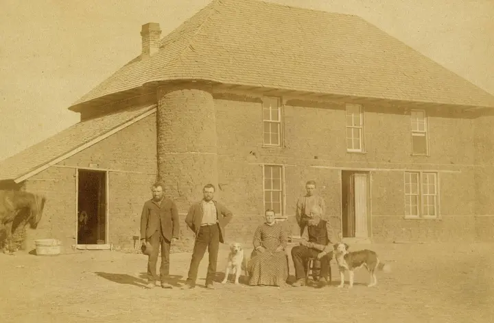 Isadore Haumont and family before their two-story sod house on French Table, north of Broken Bow, Nebraska, in 1886.