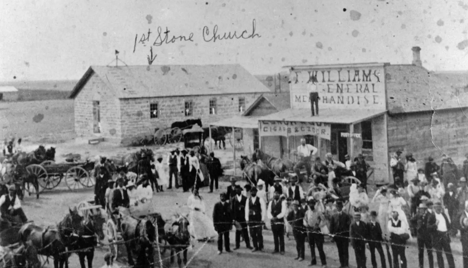 Settlers gather outside the first stone church and the general store in Nicodemus, Kansas, a town built by Black homesteaders, in the late 1800s.