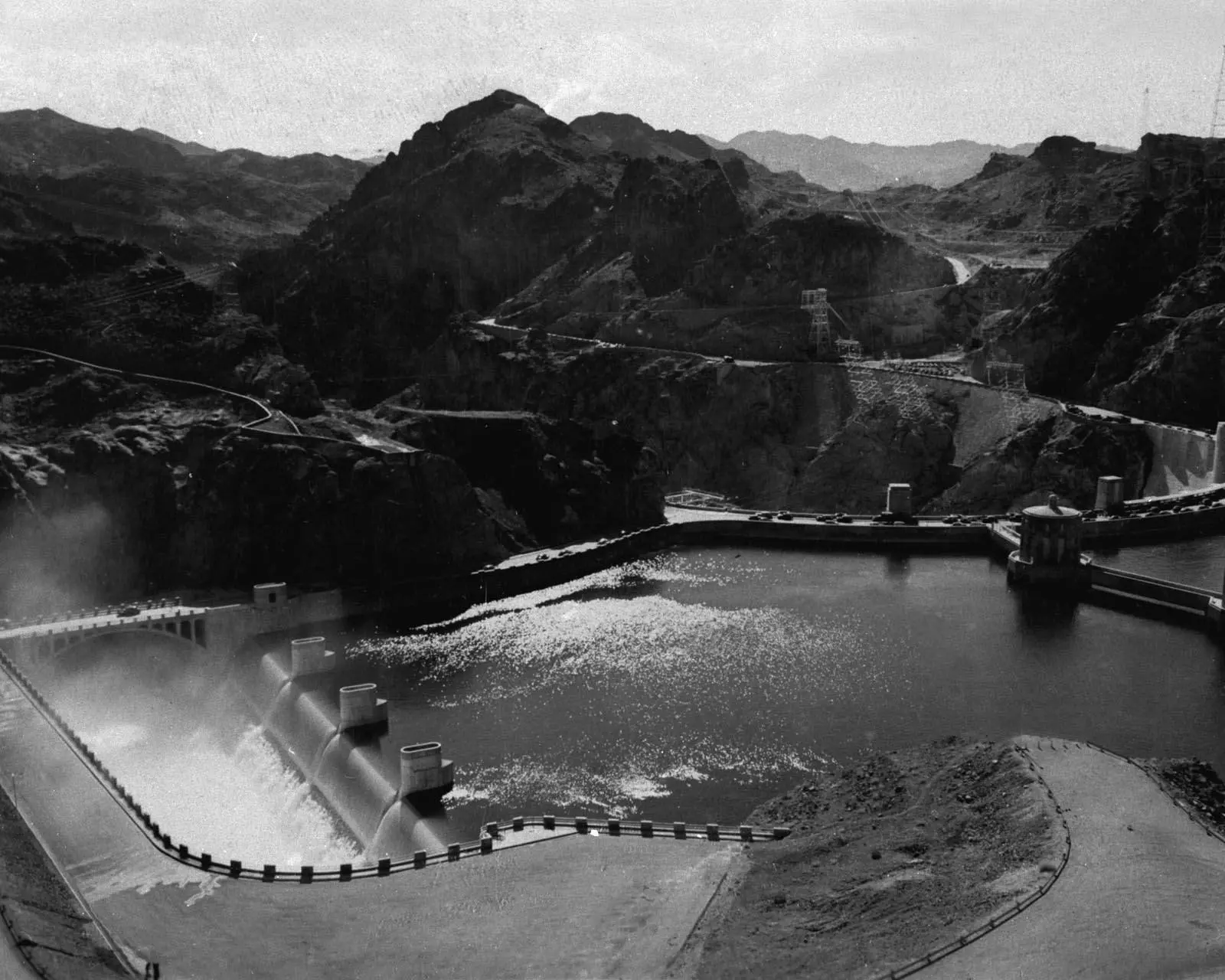 Water pours over the Arizona spillway drum gates for the first time as Lake Mead fills, August 12, 1941