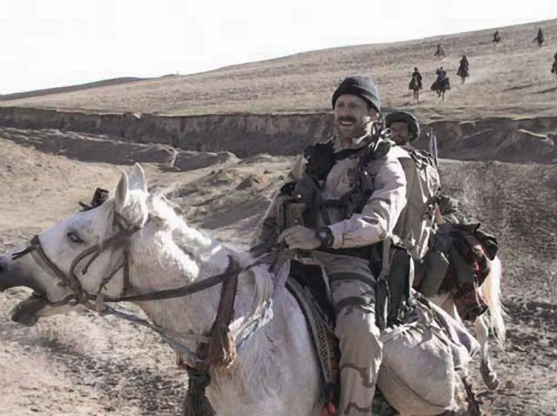 Air Force combat controller Staff Sgt. Bart Decker on horseback with Northern Alliance fighters, October 2001. He called in the B-52s and Navy jets for ODA 595