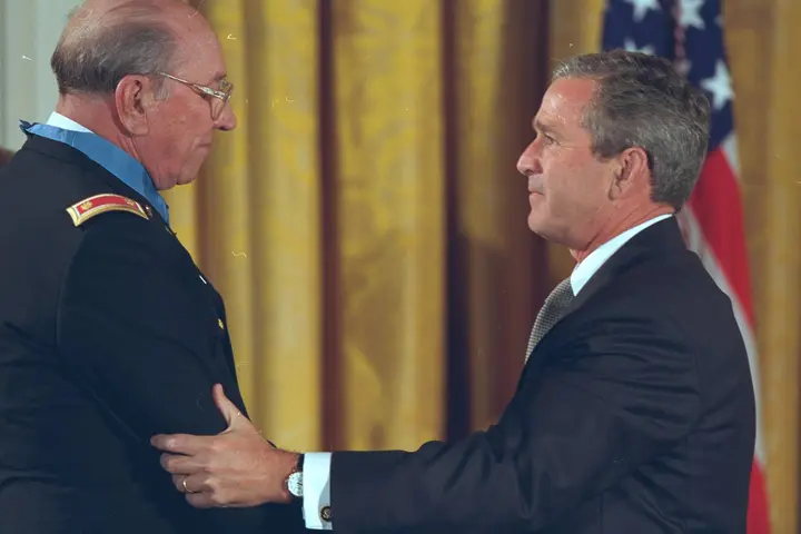 President George W. Bush presents the Medal of Honor to Ed Freeman in the East Room of the White House, 16 July 2001.