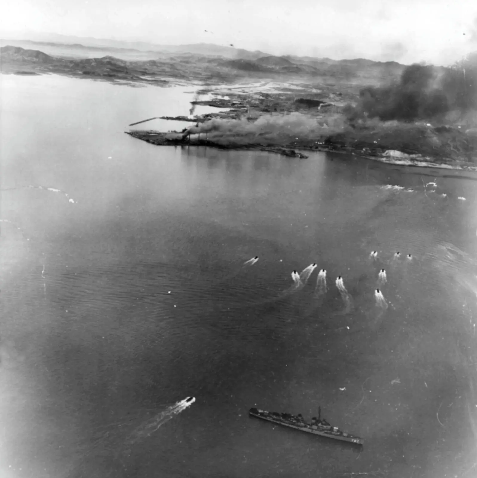 Landing craft of the first and second waves run in toward Red Beach, with the destroyer USS De Haven below, photographed from a Marine Corsair, 15 September 1950 (NH 42351).