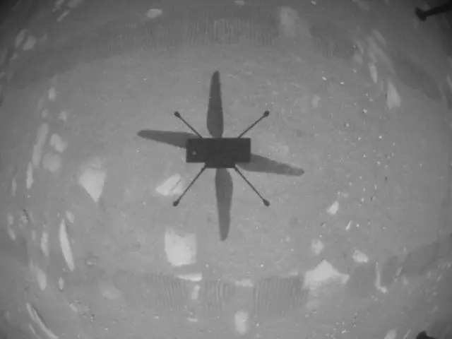 Ingenuity photographs its own shadow from about ten feet up during the first flight, 19 April 2021