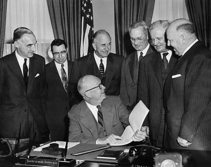 Gen. Lucius D. Clay (left), Frank Turner and the President's Advisory Committee on a National Highway Program hand President Eisenhower their report, 11 January 1955.