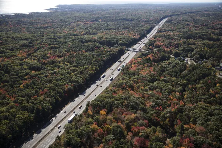 Interstate 95 runs four lanes wide through the autumn woods of southern Maine near Ogunquit, October 2017.