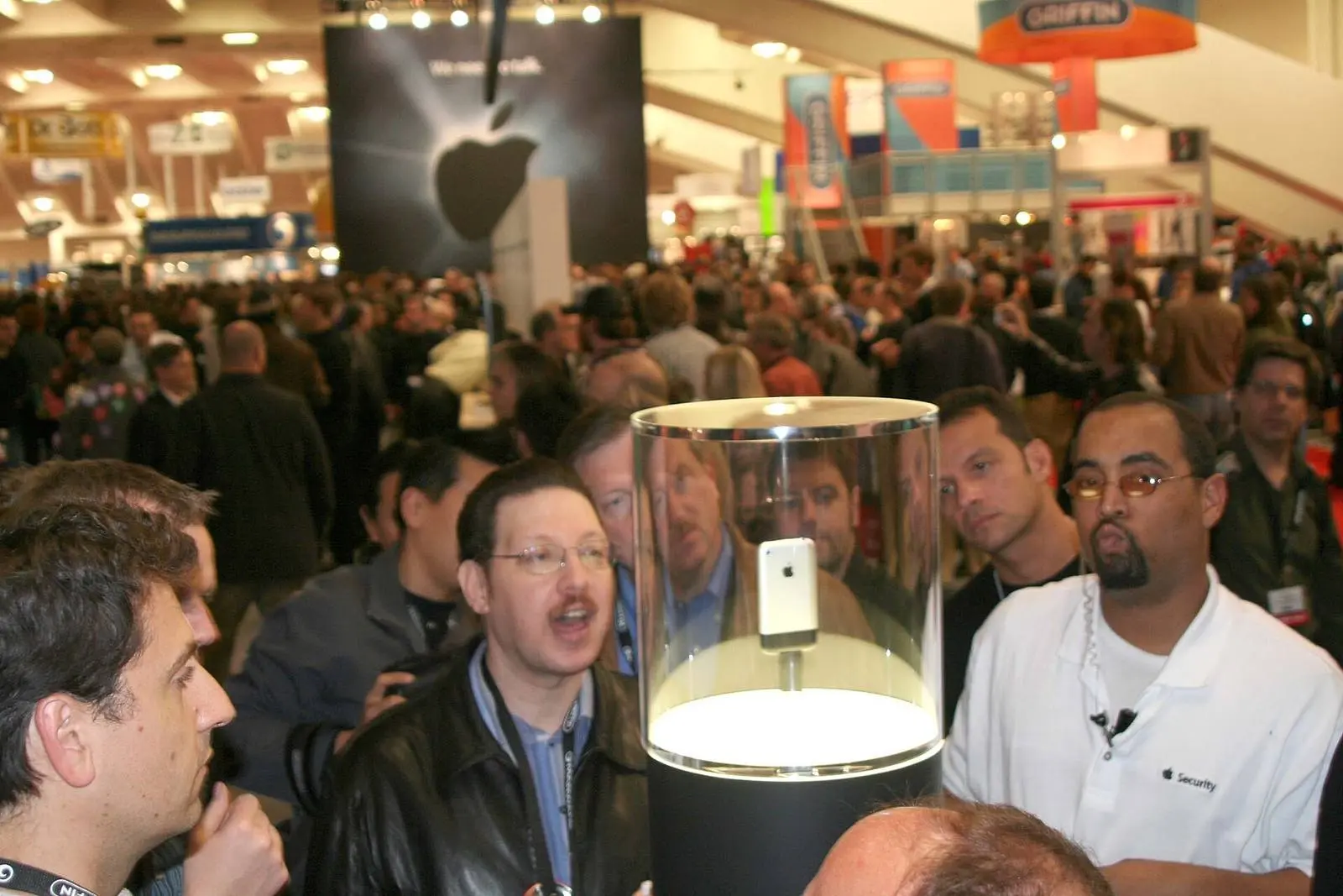 Macworld attendees crowd the glass case holding the first iPhone, San Francisco, January 2007