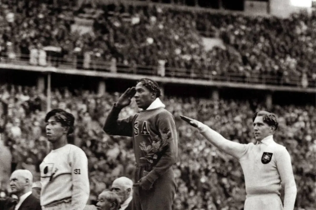 The long jump medal ceremony, Berlin, 4 August 1936: Owens salutes the flag between Naoto Tajima of Japan, third, and Luz Long of Germany, second