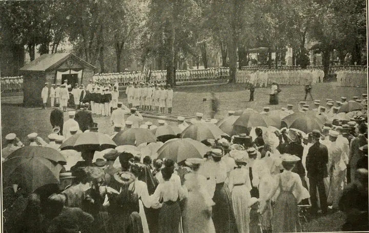 Midshipmen and crowds under umbrellas at the Naval Academy for the ceremonies honoring Jones on his return, 24 July 1905.