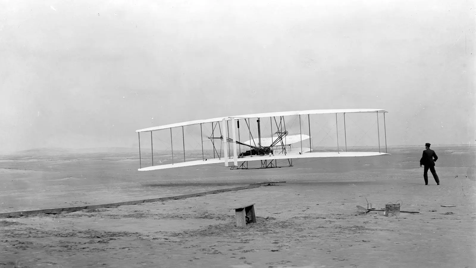 The first powered flight: Orville Wright lifts off at 10:35 a.m. as Wilbur runs alongside, Kill Devil Hills, near Kitty Hawk, N.C., December 17, 1903