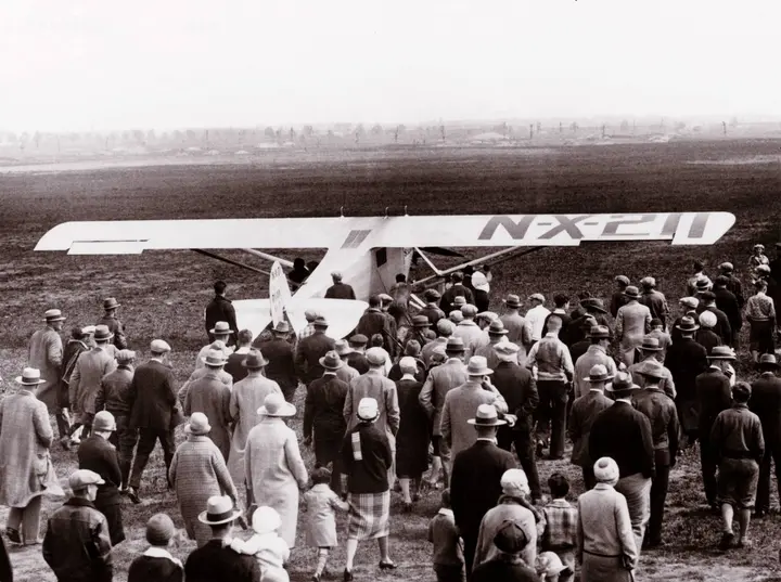 A crowd surrounds the Spirit of St. Louis at Roosevelt Field, Long Island, before Lindbergh's takeoff for Paris, 20 May 1927.