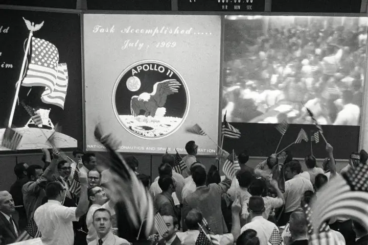Flight controllers celebrate the end of Apollo 11 in Mission Control, July 24, 1969 (S69-40023)