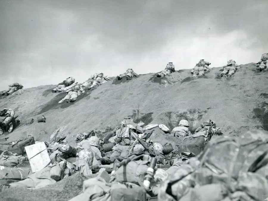 5th Marine Division Marines work up the terraces from Red Beach One, 19 February 1945