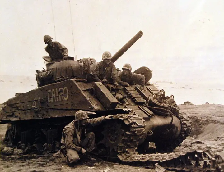 A 4th Marine Division Sherman tank, wrecked by a mine and five shell hits, with its crew unhurt, February 1945 (80-G-304853)