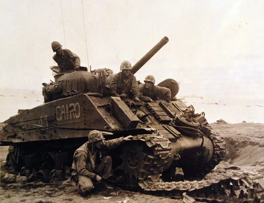 A 4th Marine Division Sherman tank, wrecked by a mine and five shell hits, with its crew unhurt, February 1945 (80-G-304853)