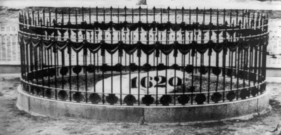 The top of Plymouth Rock inside its iron fence on the lawn of Pilgrim Hall, where it stood from 1834 to 1880.