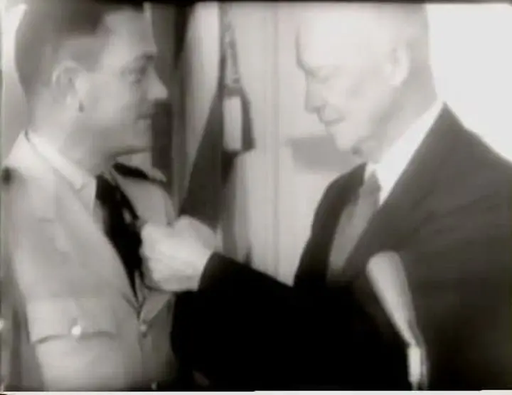 President Eisenhower pins the Legion of Merit on Cmdr. William Anderson at the White House, 8 August 1958.