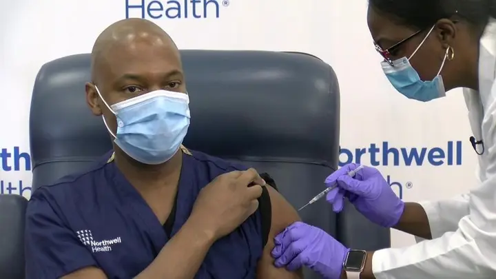 A Northwell Health frontline worker receives one of the first COVID-19 vaccinations, 14 December 2020 (video still).