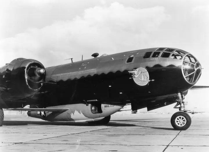 A first-generation Bell X-1 rides in the modified bomb bay of its B-29 Superfortress mothership.