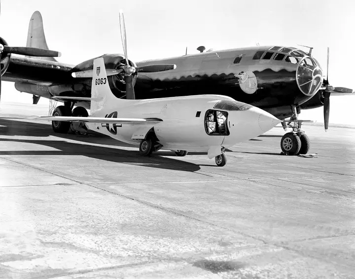 The second X-1 (#46-063) on the ramp with its B-29 launch ship at NACA's Muroc station, about 1949.