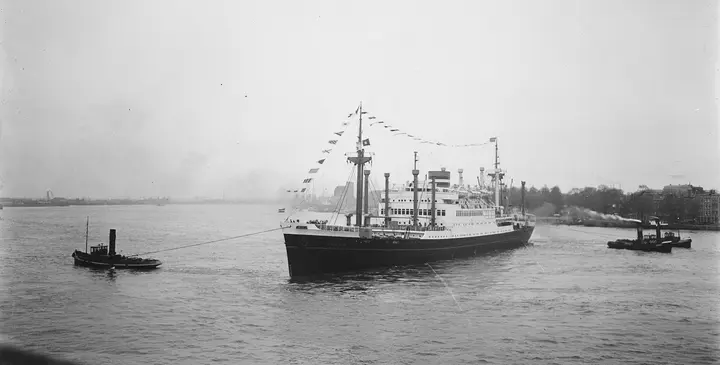 The Holland-America ship Noordam steams into Rotterdam on 26 April 1948, flags flying, with the first Marshall Plan goods for the Netherlands: wheat, farm machinery, steel and cars.