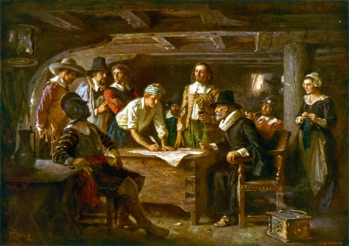 The Mayflower Compact, 1620, as imagined by Jean Leon Gerome Ferris: the men gather around a sea chest in the ship's cabin to sign.