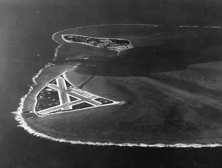 Midway Atoll from the air on 24 November 1941, with the airfield on Eastern Island in front and Sand Island beyond (80-G-451086).