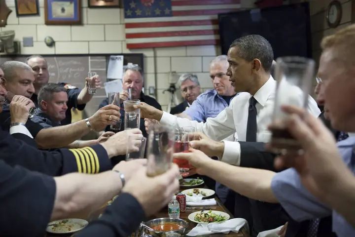 Firefighters of Engine 54, Ladder 4, Battalion 9, the “Pride of Midtown,” which lost 15 men on 9/11, toast President Obama, 5 May 2011