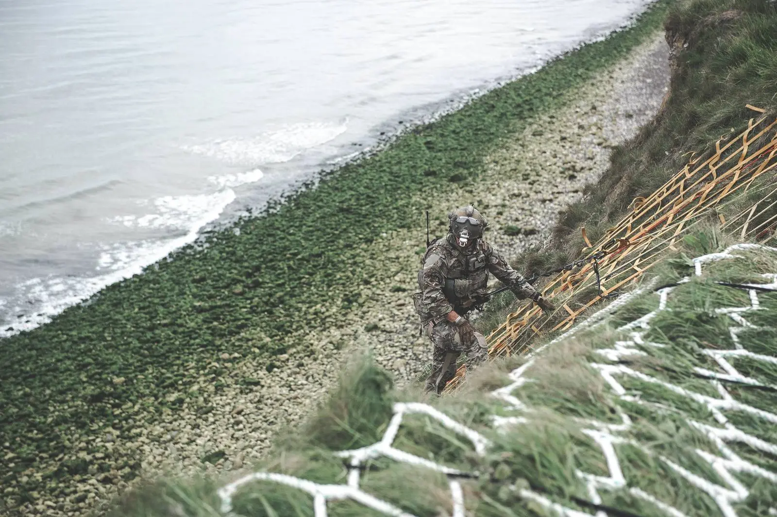 A soldier of today's 75th Ranger Regiment climbs the same cliff on 4 June 2019 to honor the men of the 2nd Ranger Battalion.