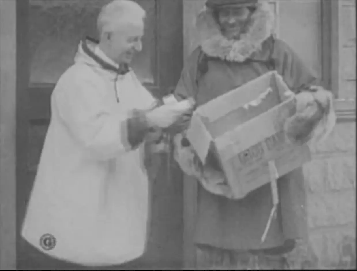 Dr. Curtis Welch receives the serum package in Nome, in a scene filmed for a Gaumont newsreel on 2 February 1925.
