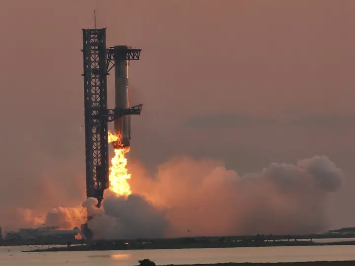 The tower’s arms close around Super Heavy Booster 12 as it returns to Starbase, 13 October 2024.