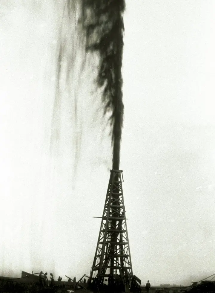The Lucas gusher blows oil more than 150 feet into the air above its derrick on Spindletop Hill, January 1901