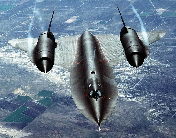 An SR-71A from overhead in 1988: the long chined nose, the delta wing and two engine nacelles nearly as long as a fighter.