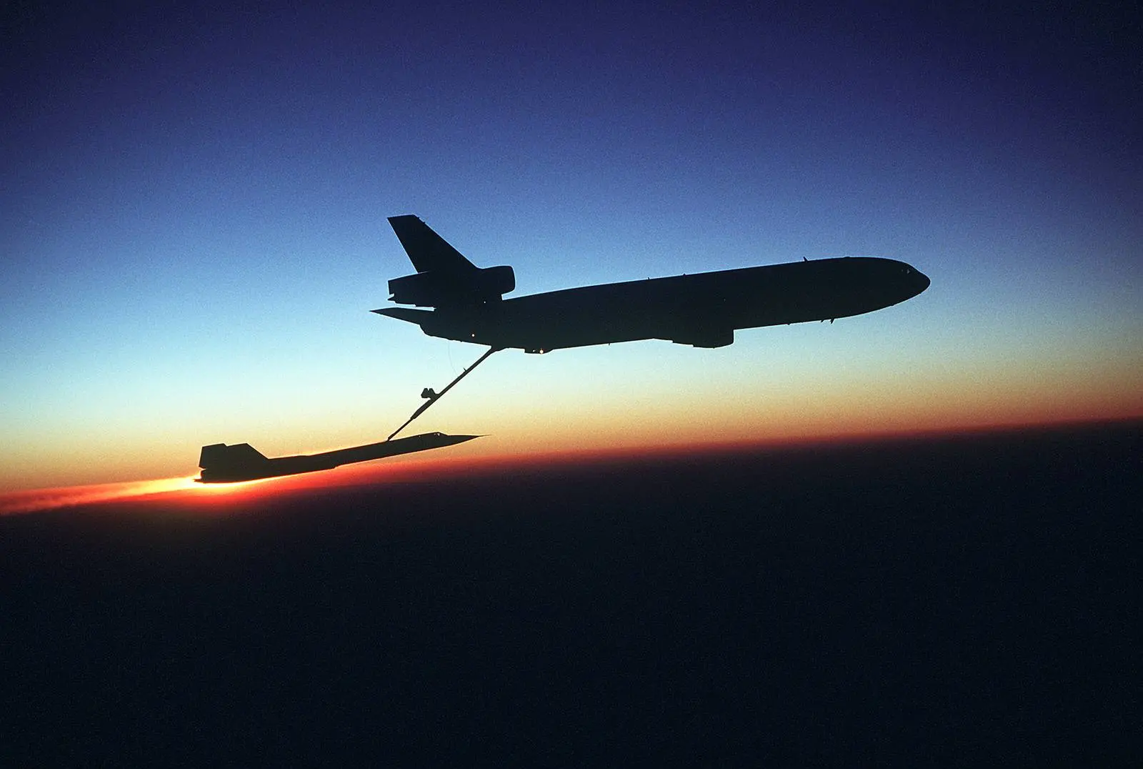 A Blackbird of the 9th Strategic Reconnaissance Wing refuels from a KC-10 Extender against the sunset.