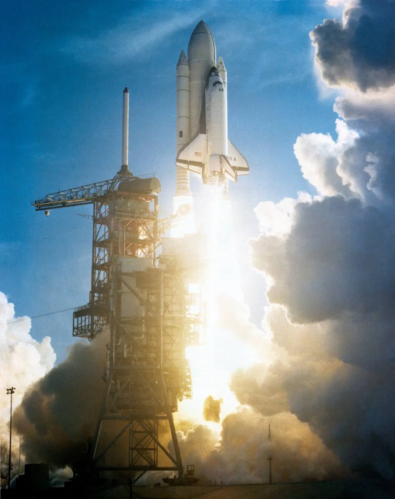 Columbia clears the launch tower on the twin pillars of its solid rocket boosters, 12 April 1981 (S81-30500)