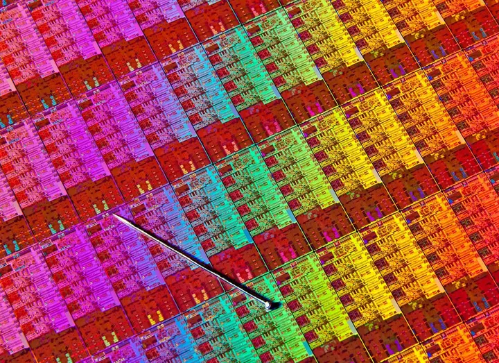 A silicon wafer of Intel Haswell processors, each die a grid of transistors far too small to see, 2012