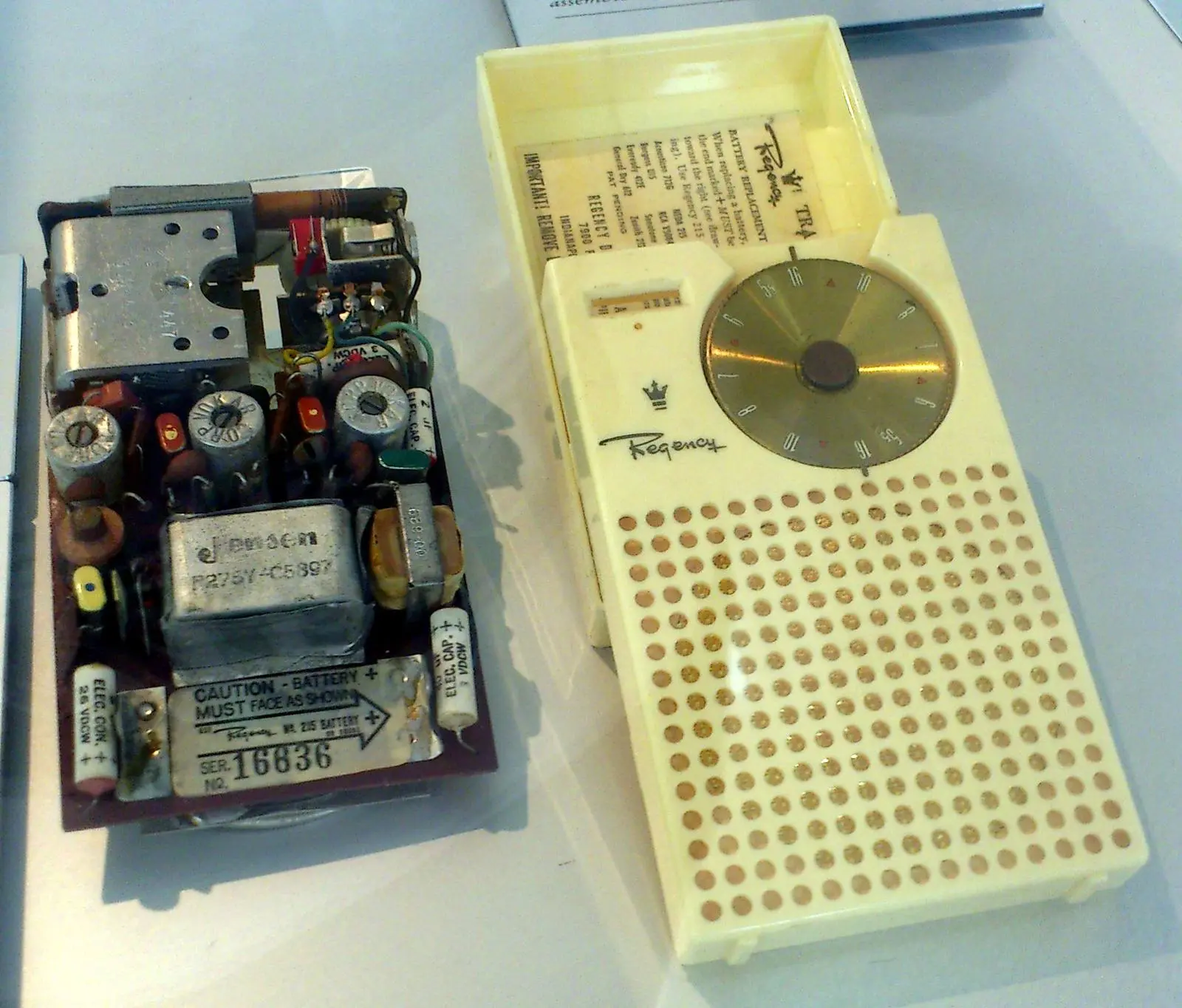 The Regency TR-1 of 1954, the first transistor radio sold, opened to show its circuit board